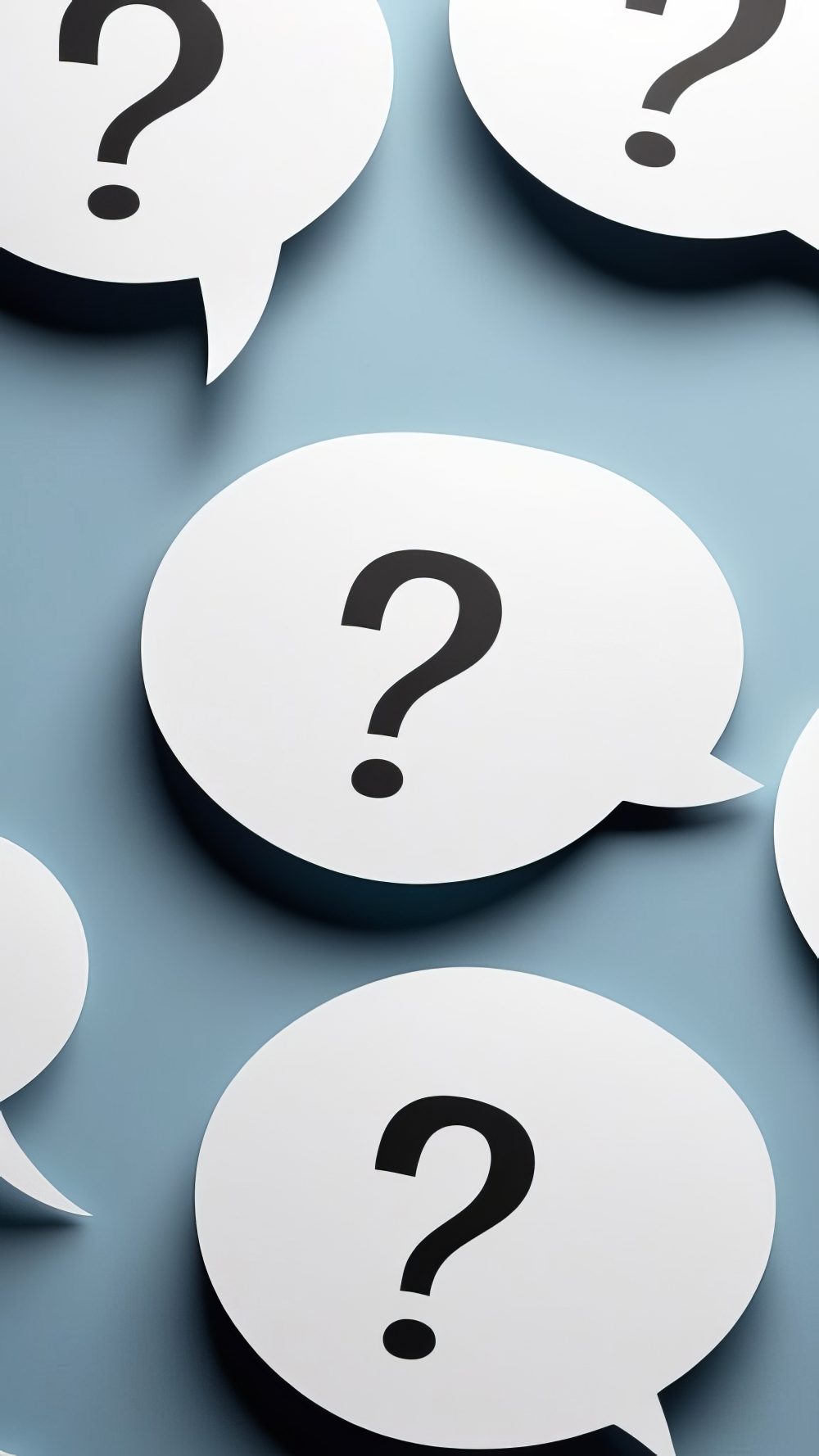stock image with black question marks inside white comment bubbles over a blue background